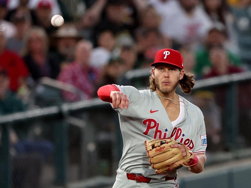 May 23, 2025; West Sacramento, California, USA; Philadelphia Phillies third baseman Alec Bohm (28) throws to first for an out against the Athletics during the fifth inning at Sutter Health Park. Mandatory Credit: Dennis Lee-Imagn Images