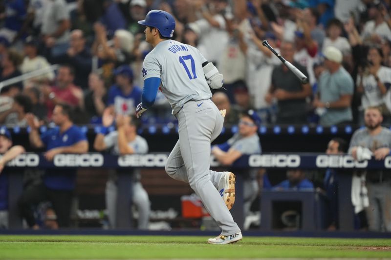 Sep 17, 2024; Miami, Florida, USA;  Los Angeles Dodgers designated hitter Shohei Ohtani (17) flips his bat after hitting a two-run home run in the third inning against the Miami Marlins at loanDepot Park. Mandatory Credit: Jim Rassol-Imagn Images