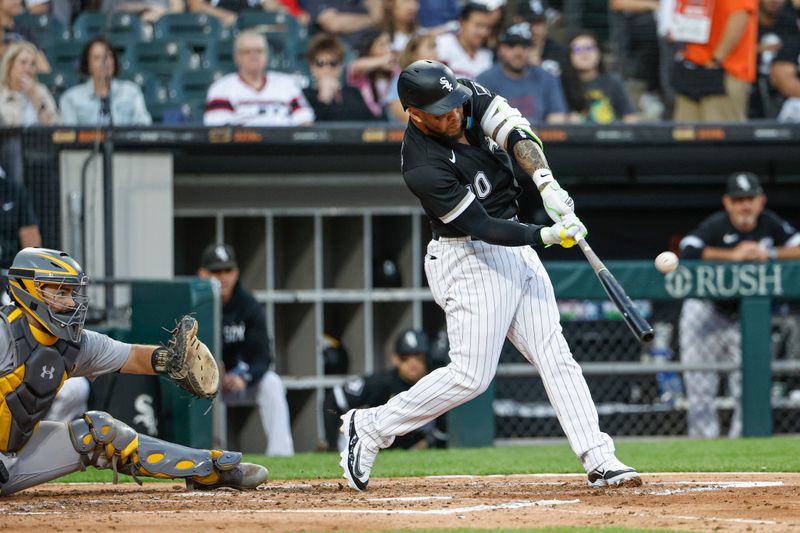 Aug 26, 2023; Chicago, Illinois, USA; Chicago White Sox third baseman Yoan Moncada (10) hits a three-run home run against the Oakland Athletics during the third inning at Guaranteed Rate Field. Mandatory Credit: Kamil Krzaczynski-USA TODAY Sports