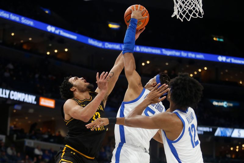 Jan 19, 2023; Memphis, Tennessee, USA; Wichita State Shockers forward James Rojas (33) shoots as Memphis Tigers forward Kaodirichi Akobundu-Ehiogu (5) defends during the first half at FedExForum. Mandatory Credit: Petre Thomas-USA TODAY Sports