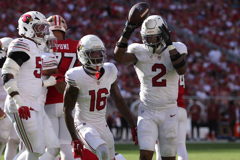 Arizona Cardinals linebacker Mack Wilson Sr. (2) celebrates next to cornerback Max Melton (16) after recovering a fumble by San Francisco 49ers running back Jordan Mason during the second half of an NFL football game in Santa Clara, Calif., Sunday, Oct. 6, 2024. (AP Photo/Jed Jacobsohn)