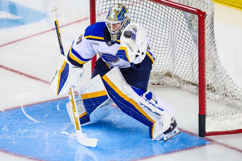 Jan 23, 2024; Calgary, Alberta, CAN; St. Louis Blues goaltender Jordan Binnington (50) guards his net during the warmup period against the Calgary Flames at Scotiabank Saddledome. Mandatory Credit: Sergei Belski-USA TODAY Sports