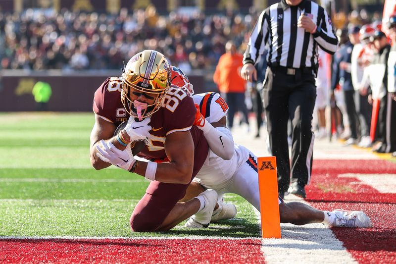 Nov 4, 2023; Minneapolis, Minnesota, USA; Minnesota Golden Gophers tight end Brevyn Spann-Ford (88) dives for a touchdown while Illinois Fighting Illini defensive back Miles Scott (10) defends during the first half at Huntington Bank Stadium. Mandatory Credit: Matt Krohn-USA TODAY Sports