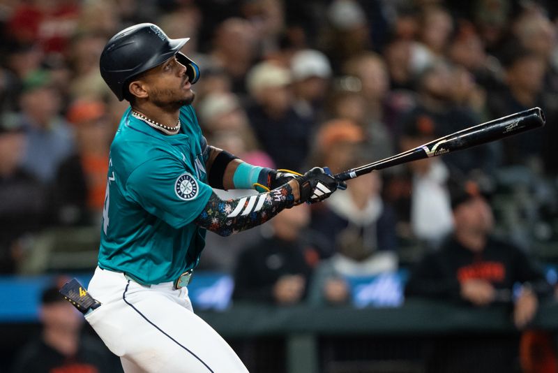 Aug 23, 2024; Seattle, Washington, USA; Seattle Mariners centerfielder Julio Rodriguez (44) hits a double during the seventh inning against the San Francisco Giants at T-Mobile Park. Mandatory Credit: Stephen Brashear-USA TODAY Sports