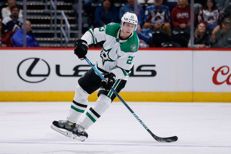 Oct 5, 2022; Denver, Colorado, USA; Dallas Stars defenseman Esa Lindell (23) controls the puck in the third period against the Colorado Avalanche at Ball Arena. Mandatory Credit: Isaiah J. Downing-USA TODAY Sports