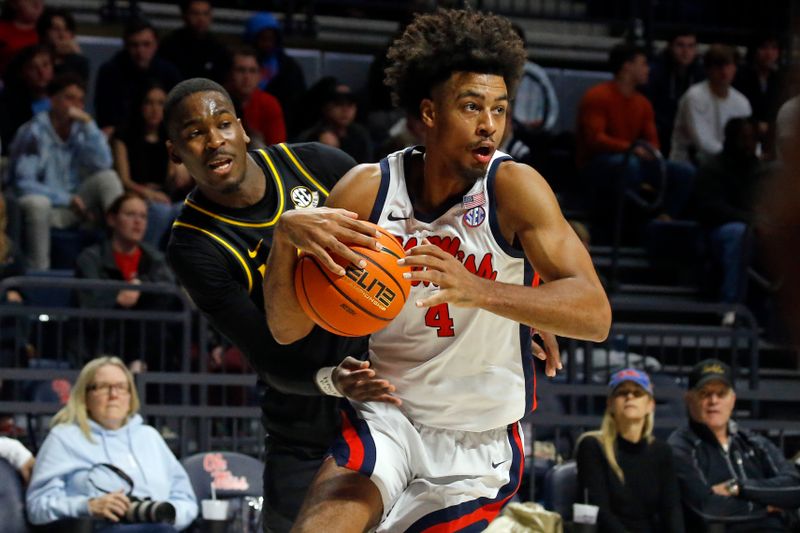 Jan 24, 2023; Oxford, Mississippi, USA; Mississippi Rebels forward Jaemyn Brakefield (4) drives to the basket as Missouri Tigers guard D'Moi Hodge (5) defends during the second half at The Sandy and John Black Pavilion at Ole Miss. Mandatory Credit: Petre Thomas-USA TODAY Sports