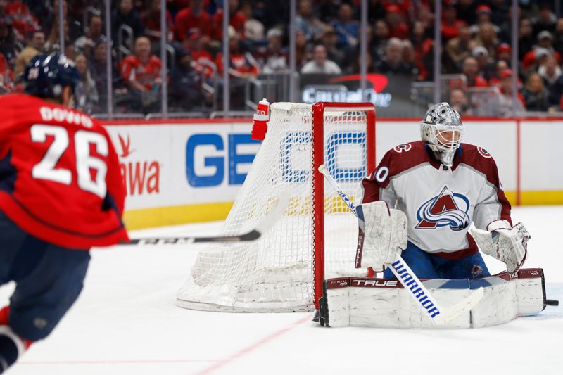 Feb 13, 2024; Washington, District of Columbia, USA; Colorado Avalanche goaltender Alexandar Georgiev (40) makes a save on Washington Capitals right wing Nic Dowd (26) in the third period at Capital One Arena. Mandatory Credit: Geoff Burke-USA TODAY Sports