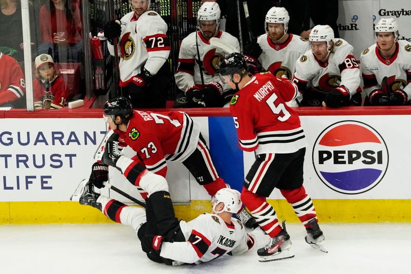 Mar 5, 2025; Chicago, Illinois, USA; Chicago Blackhawks left wing Lukas Reichel (73) knocks Ottawa Senators left wing Brady Tkachuk (7) to the ice during the first period at United Center. Mandatory Credit: David Banks-Imagn Images