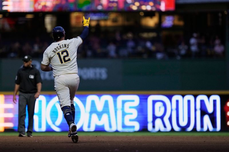 Jul 10, 2024; Milwaukee, Wisconsin, USA;  Milwaukee Brewers first baseman Rhys Hoskins (12) rounds the bases after hitting a home run during the fifth inning against the Pittsburgh Pirates at American Family Field. Mandatory Credit: Jeff Hanisch-USA TODAY Sports