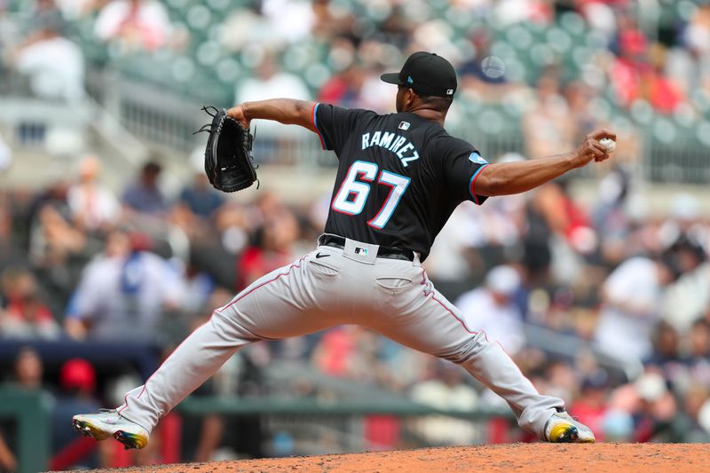 Aug 4, 2024; Cumberland, Georgia, USA; Miami Marlins relief pitcher Emmanuel Ramirez (67) pitches during a game against the Atlanta Braves in the eight inning at Truist Park. Mandatory Credit: Mady Mertens-USA TODAY Sports