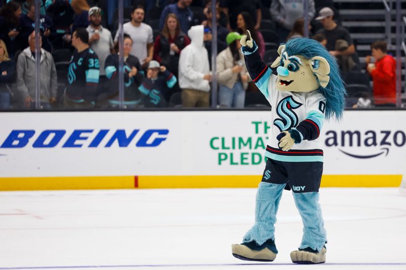 Oct 1, 2022; Seattle, Washington, USA; Seattle Kraken mascot Buoy celebrates on the ice following a 4-0 victory against the Vancouver Canucks at Climate Pledge Arena. Mandatory Credit: Joe Nicholson-USA TODAY Sports