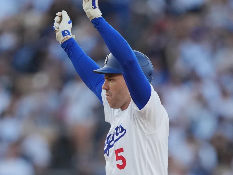 Jun 15, 2024; Los Angeles, California, USA; Los Angeles Dodgers first baseman Freddie Freeman (5) gestures after hitting a double in the fourth inning against the Kansas City Royals at Dodger Stadium. Mandatory Credit: Kirby Lee-USA TODAY Sports