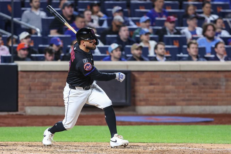 Apr 22, 2025; New York City, New York, USA;  New York Mets catcher Luis Torrens (13) hits a two run single in the seventh inning against the Philadelphia Phillies at Citi Field. Mandatory Credit: Wendell Cruz-Imagn Images