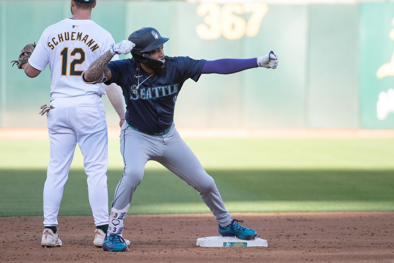 Jun 4, 2024; Oakland, California, USA; Seattle Mariners shortstop J.P. Crawford (3) motions to his team mates after hitting a double against the Oakland Athletics during the second inning at Oakland-Alameda County Coliseum. Mandatory Credit: Ed Szczepanski-USA TODAY Sports