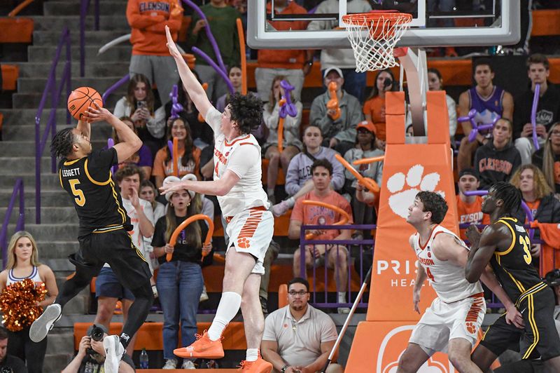 Feb 27, 2024; Clemson, South Carolina, USA; Clemson junior forward Ian Schieffelin (4) defends a shot by Pitt guard Ishmael Leggett (5) during the second half at Littlejohn Coliseum. Mandatory Credit: Ken Ruinard-USA TODAY Sports