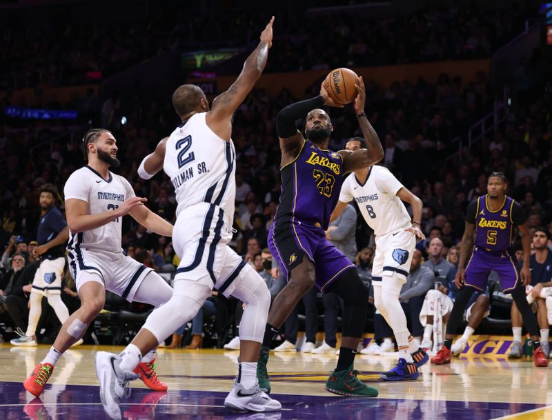 LOS ANGELES, CALIFORNIA - JANUARY 05: LeBron James #23 of the Los Angeles Lakers looks to shoot in front of David Roddy #21 and Xavier Tillman #2 of the Memphis Grizzlies during the first half at Crypto.com Arena on January 05, 2024 in Los Angeles, California. User is consenting to the terms and conditions of the Getty Images License Agreement. (Photo by Harry How/Getty Images)