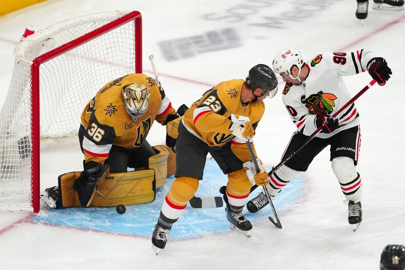 Apr 16, 2024; Las Vegas, Nevada, USA; Vegas Golden Knights goaltender Logan Thompson (36) makes a save against Chicago Blackhawks center Tyler Johnson (90) as Vegas Golden Knights defenseman Alec Martinez (23) attempts to stop the play during the first period at T-Mobile Arena. Mandatory Credit: Stephen R. Sylvanie-USA TODAY Sports