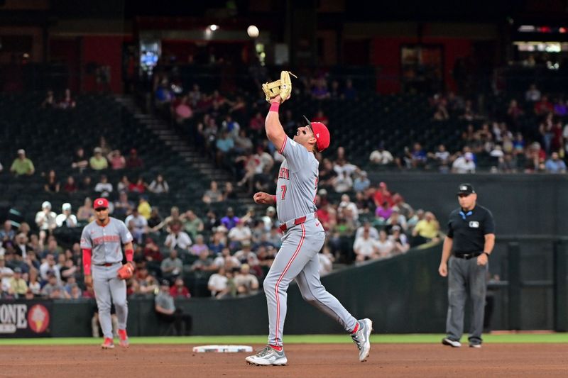 May 15, 2024; Phoenix, Arizona, USA;  Cincinnati Reds second baseman Spencer Steer (7) catches a fly ball in the sixth inning against the Arizona Diamondbacks at Chase Field. Mandatory Credit: Matt Kartozian-USA TODAY Sports