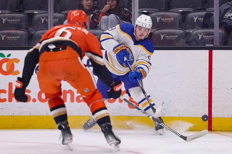 Nov 22, 2024; Anaheim, California, USA; Buffalo Sabres left wing Zach Benson (9) passes against Anaheim Ducks defenseman Brian Dumoulin (6) during the first period at Honda Center. Mandatory Credit: Ryan Sun-Imagn Images