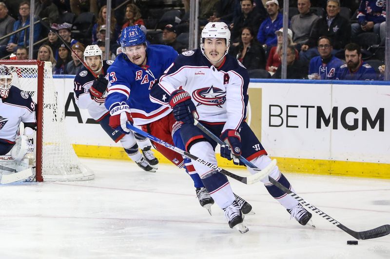 Nov 12, 2023; New York, New York, USA; Columbus Blue Jackets defenseman Zach Werenski (8) and New York Rangers left wing Alexis Lafreniere (13) chases the puck in the first period at Madison Square Garden. Mandatory Credit: Wendell Cruz-USA TODAY Sports