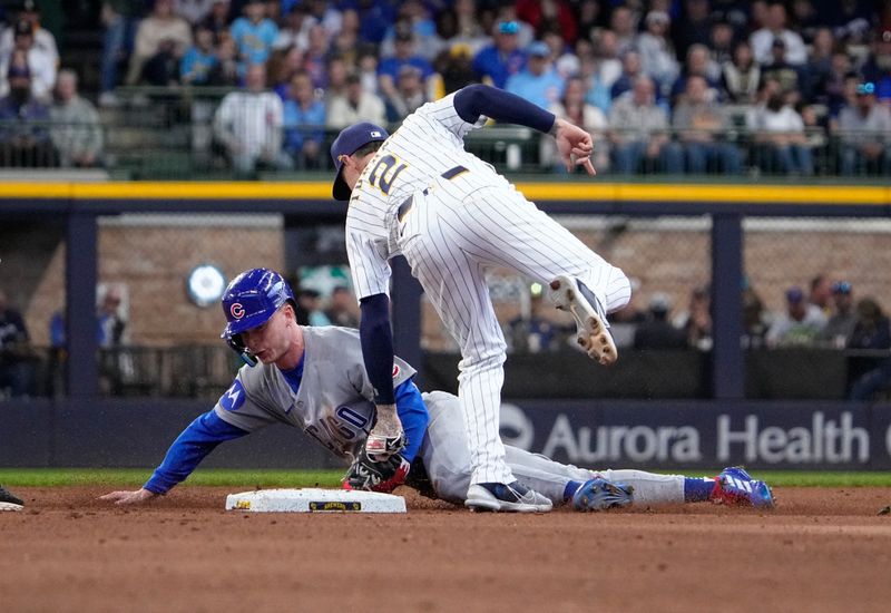 May 4, 2025; Milwaukee, Wisconsin, USA; Milwaukee Brewers second base Brice Turang (2) tags out Chicago Cubs outfielder Pete Crow-Armstrong (4) as he attempt to steal second base in the fifth inning at American Family Field. Mandatory Credit: Michael McLoone-Imagn Images