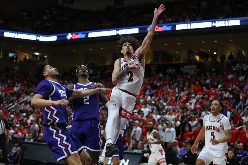 Feb 20, 2024; Lubbock, Texas, USA;  Texas Tech Red Raiders guard Pop Isaacs (2) shoots against TCU Horned Frogs forward Emanuel Miller (2) in the first half at United Supermarkets Arena. Mandatory Credit: Michael C. Johnson-USA TODAY Sports