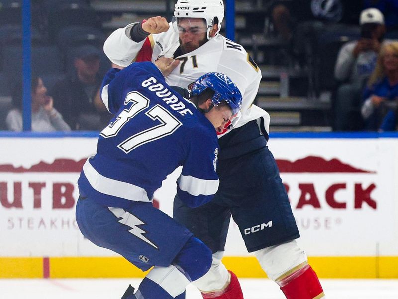 Oct 2, 2025; Tampa, Florida, USA; Florida Panthers center Luke Kunin (71) and Tampa Bay Lightning center Yanni Gourde (37) fight in the third period at Benchmark International Arena. Mandatory Credit: Nathan Ray Seebeck-Imagn Images