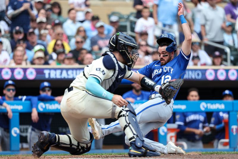 May 25, 2025; Minneapolis, Minnesota, USA; Kansas City Royals left fielder Nick Loftin (12) scores the go ahead run on a double hit third baseman Maikel Garcia (11) during the tenth inning against the Minnesota Twins at Target Field. Mandatory Credit: Matt Krohn-Imagn Images