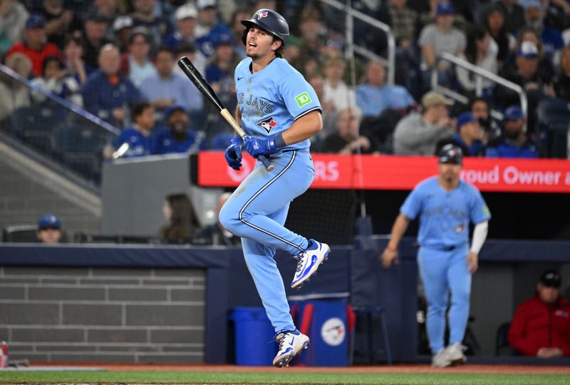 May 1, 2025; Toronto, Ontario, CAN;  Toronto Blue Jays third baseman Addison Barger (47) reacts after being hit by a pitch from Boston Red Sox pitcher Tanner Houck (89) in the seventh inning at Rogers Centre. Mandatory Credit: Dan Hamilton-Imagn Images