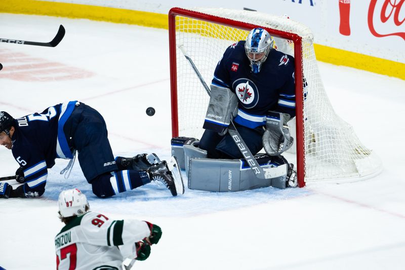 Feb 20, 2024; Winnipeg, Manitoba, CAN; Minnesota Wild forward Kirill Kaprizov (97) scores on Winnipeg Jets goalie Laurent Boissoit (39) during third period at Canada Life Centre. Mandatory Credit: Terrence Lee-USA TODAY Sports