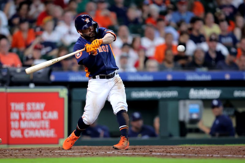 Jul 30, 2023; Houston, Texas, USA; Houston Astros second baseman Jose Altuve (27) hits a single against the Tampa Bay Rays during the fifth inning at Minute Maid Park. Mandatory Credit: Erik Williams-USA TODAY Sports