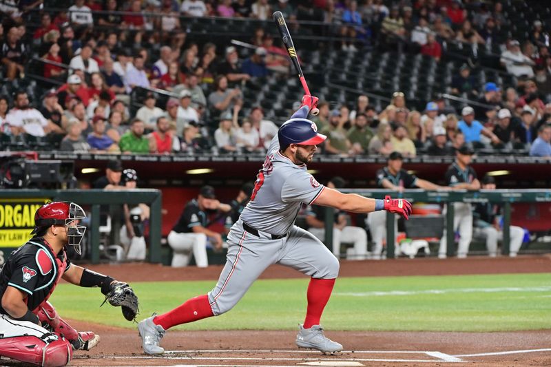 Jul 29, 2024; Phoenix, Arizona, USA;  Washington Nationals first baseman Juan Yepez (18) singles in the first inning against the Arizona Diamondbacks at Chase Field. Mandatory Credit: Matt Kartozian-USA TODAY Sports