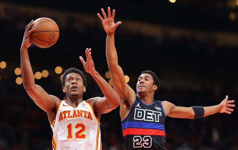 ATLANTA, GEORGIA - APRIL 03:  De'Andre Hunter #12 of the Atlanta Hawks drives past Jaden Ivey #23 of the Detroit Pistons during the first quarter at State Farm Arena on April 03, 2024 in Atlanta, Georgia.  NOTE TO USER: User expressly acknowledges and agrees that, by downloading and/or using this photograph, user is consenting to the terms and conditions of the Getty Images License Agreement.  (Photo by Kevin C. Cox/Getty Images)