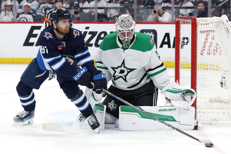 May 9, 2025; Winnipeg, Manitoba, CAN; Winnipeg Jets left wing Kyle Connor (81) stretches for the puck in front of Dallas Stars goaltender Jake Oettinger (29) in the second period in game two of the second round of the 2025 Stanley Cup Playoffs at Canada Life Centre. Mandatory Credit: James Carey Lauder-Imagn Images