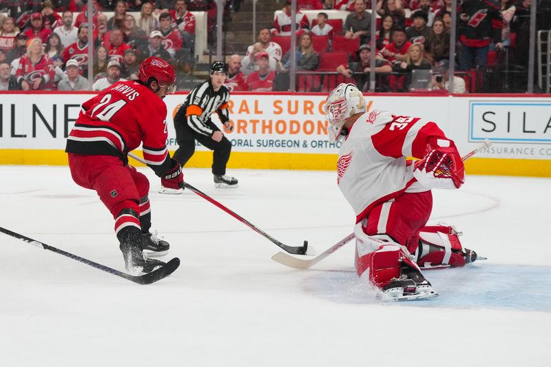 Feb 28, 2026; Raleigh, North Carolina, USA;  Detroit Red Wings goaltender Cam Talbot (39) stops the scoring attempt by Carolina Hurricanes center Seth Jarvis (24) during the first period at Lenovo Center. Mandatory Credit: James Guillory-Imagn Images