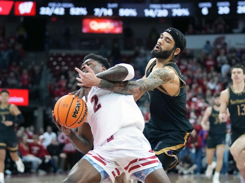 Jan 13, 2024; Madison, Wisconsin, USA;Northwestern Wildcats guard Boo Buie (0) fouls Wisconsin Badgers guard AJ Storr (2) from behind on a layup attempt during the second half at the Kohl Center. Mandatory Credit: Kayla Wolf-USA TODAY Sports