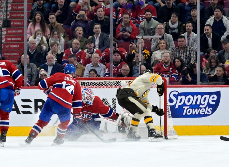 Mar 14, 2024; Montreal, Quebec, CAN; Boston Bruins forward Jake DeBrusk (74) scores the winning goal against Montreal Canadiens goalie Sam Montembeault (35) during the overtime period at the Bell Centre. Mandatory Credit: Eric Bolte-USA TODAY Sports