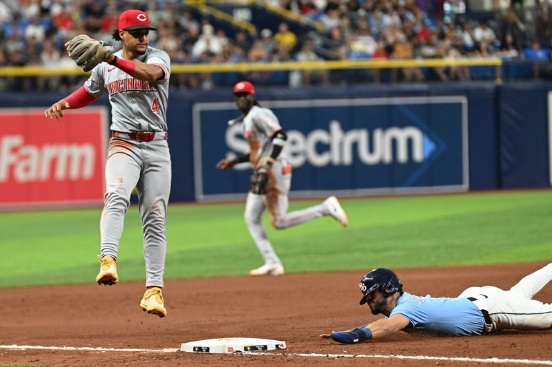 Jul 28, 2024; St. Petersburg, Florida, USA; Tampa Bay Rays pinch runner Jose Caballero (7) slides into third base  in the eighth inning against the Cincinnati Reds at Tropicana Field. Mandatory Credit: Jonathan Dyer-USA TODAY Sports