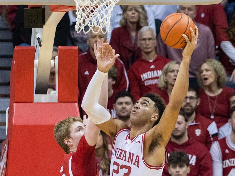 Jan 14, 2023; Bloomington, Indiana, USA; Indiana Hoosiers forward Trayce Jackson-Davis (23) shoots the ball while Wisconsin Badgers forward Steven Crowl (22) defends in the second half at Simon Skjodt Assembly Hall. Mandatory Credit: Trevor Ruszkowski-USA TODAY Sports