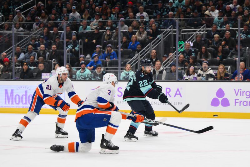 Nov 16, 2023; Seattle, Washington, USA; Seattle Kraken right wing Oliver Bjorkstrand (22) passes the puck while defended by New York Islanders center Kyle Palmieri (21) and defenseman Adam Pelech (3) during the first period at Climate Pledge Arena. Mandatory Credit: Steven Bisig-USA TODAY Sports