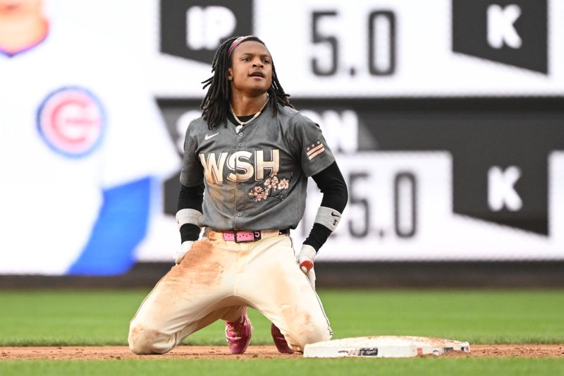 Aug 31, 2024; Washington, District of Columbia, USA; Washington Nationals shortstop CJ Abrams (5) kneels by second base after being thrown out during a stolen base attempt against the Chicago Cubs during the sixth inning at Nationals Park. Mandatory Credit: Rafael Suanes-USA TODAY Sports