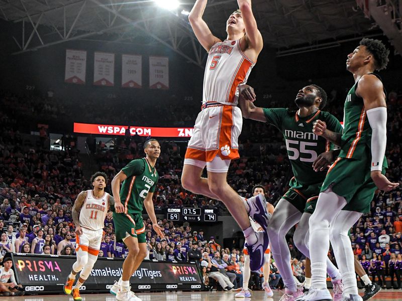 Feb 4, 2023; Clemson, South Carolina, USA; Clemson forward Hunter Tyson (5) shoots near Miami guard Isaiah Wong (2) during the second half at Littlejohn Coliseum in Clemson, S.C. Saturday, Feb. 4, 2023.  Mandatory Credit: Ken Ruinard-USA TODAY Sports