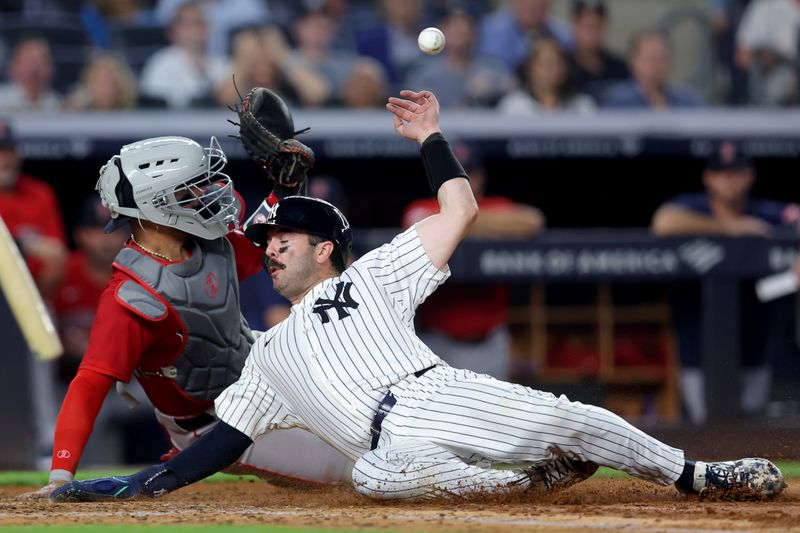 Jun 6, 2025; Bronx, New York, USA; New York Yankees catcher Austin Wells (28) scores against Boston Red Sox catcher Carlos Narvaez (75) on a double by Yankees right fielder Aaron Judge (99) during the fifth inning at Yankee Stadium. Mandatory Credit: Brad Penner-Imagn Images