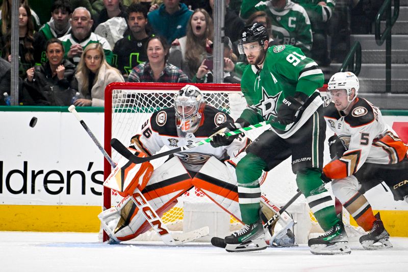 Jan 25, 2024; Dallas, Texas, USA; Anaheim Ducks goaltender John Gibson (36) and Dallas Stars center Tyler Seguin (91) look for the puck in the Ducks zone during the third period at the American Airlines Center. Mandatory Credit: Jerome Miron-USA TODAY Sports