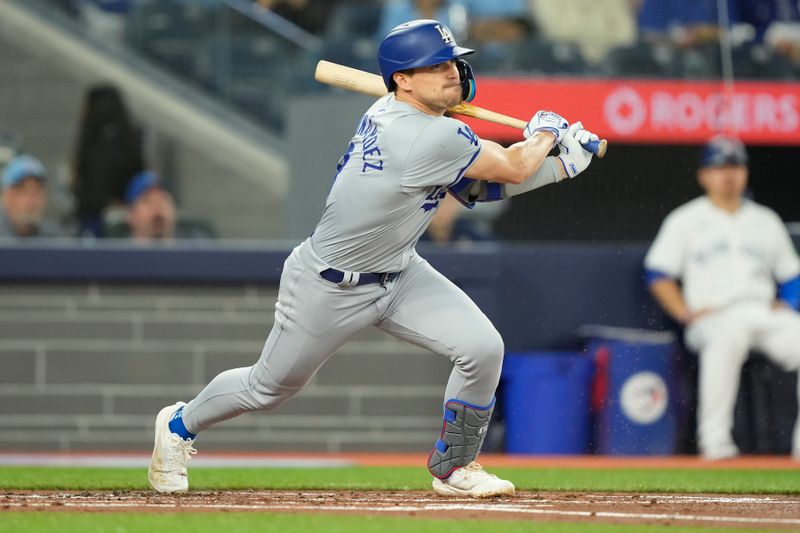 Apr 27, 2024; Toronto, Ontario, CAN; Los Angeles Dodgers third baseman Enrique Hernandez (8) hits a single against the Toronto Blue Jays during the second inning at Rogers Centre. Mandatory Credit: John E. Sokolowski-USA TODAY Sports