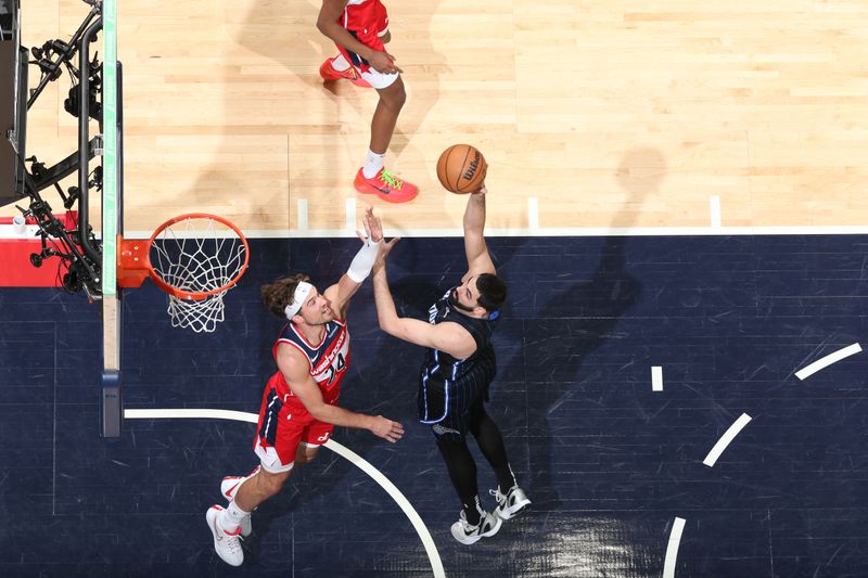 WASHINGTON, DC -? MARCH 6:  Goga Bitadze #35 of the Orlando Magic goes to the basket during the game on March 6, 2024 at Capital One Arena in Washington, DC. NOTE TO USER: User expressly acknowledges and agrees that, by downloading and or using this Photograph, user is consenting to the terms and conditions of the Getty Images License Agreement. Mandatory Copyright Notice: Copyright 2024 NBAE (Photo by Stephen Gosling/NBAE via Getty Images)