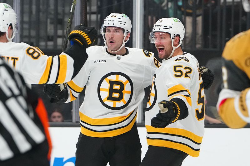 Oct 16, 2025; Las Vegas, Nevada, USA; Boston Bruins left wing Tanner Jeannot (84) celebrates with Boston Bruins center Sean Kuraly (52) after scoring a goal against the Vegas Golden Knights during the first period at T-Mobile Arena. Mandatory Credit: Stephen R. Sylvanie-Imagn Images