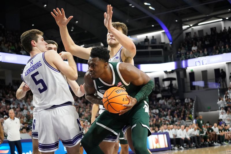 Jan 7, 2024; Evanston, Illinois, USA; Northwestern Wildcats guard Ryan Langborg (5) defends Michigan State Spartans guard Jaden Akins (3) during the first half at Welsh-Ryan Arena. Mandatory Credit: David Banks-USA TODAY Sports