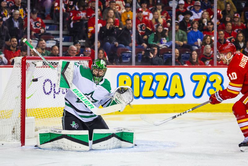 Nov 30, 2023; Calgary, Alberta, CAN; Dallas Stars goaltender Scott Wedgewood (41) makes a save against Calgary Flames center Jonathan Huberdeau (10) during the second period at Scotiabank Saddledome. Mandatory Credit: Sergei Belski-USA TODAY Sports