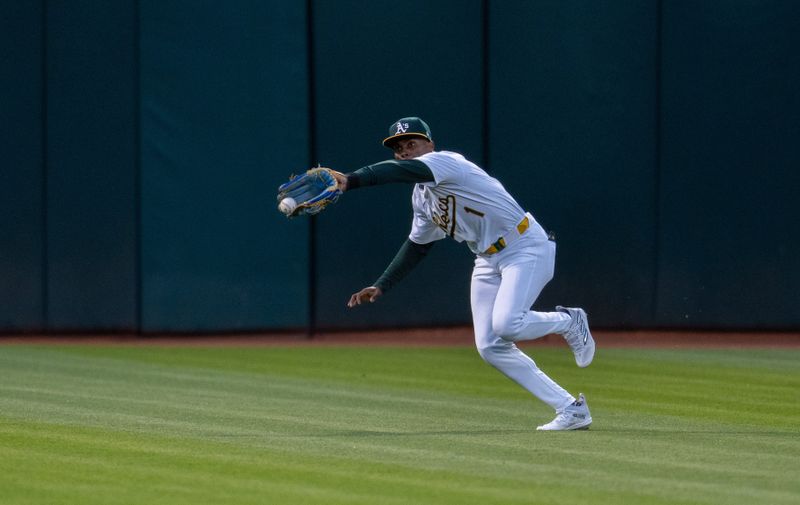 May 6, 2024; Oakland, California, USA; Oakland Athletics outfielder Esteury Ruiz (1) fields a fly ball during the sixth inning against the Texas Rangers at Oakland-Alameda County Coliseum. Mandatory Credit: Neville E. Guard-USA TODAY Sports